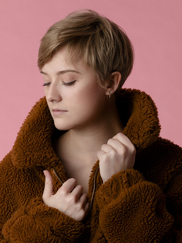 A portrait of a woman wearing a fluffy coat