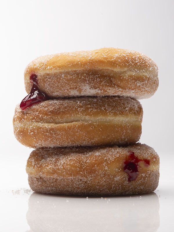  stacked jelly doughnuts, close up, high key